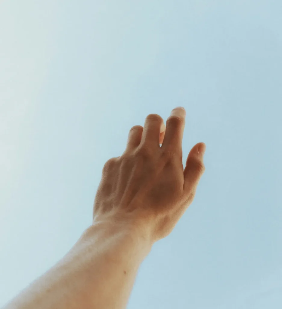 hand reaching out to the sky