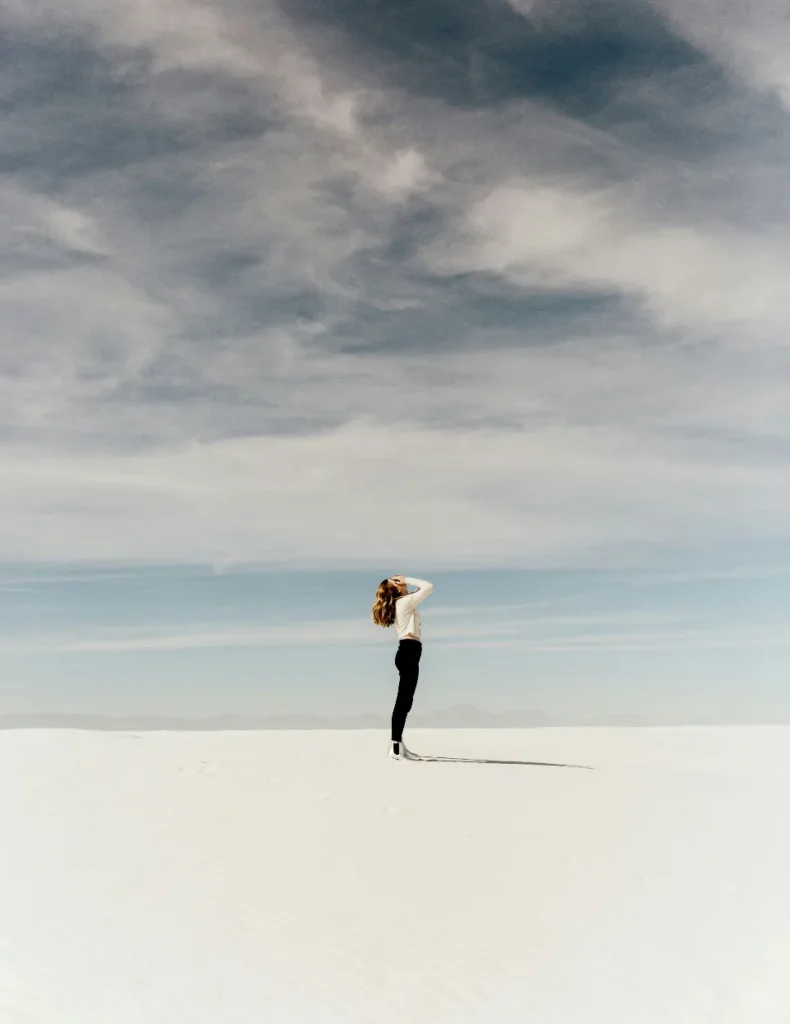 woman on beach with clouds